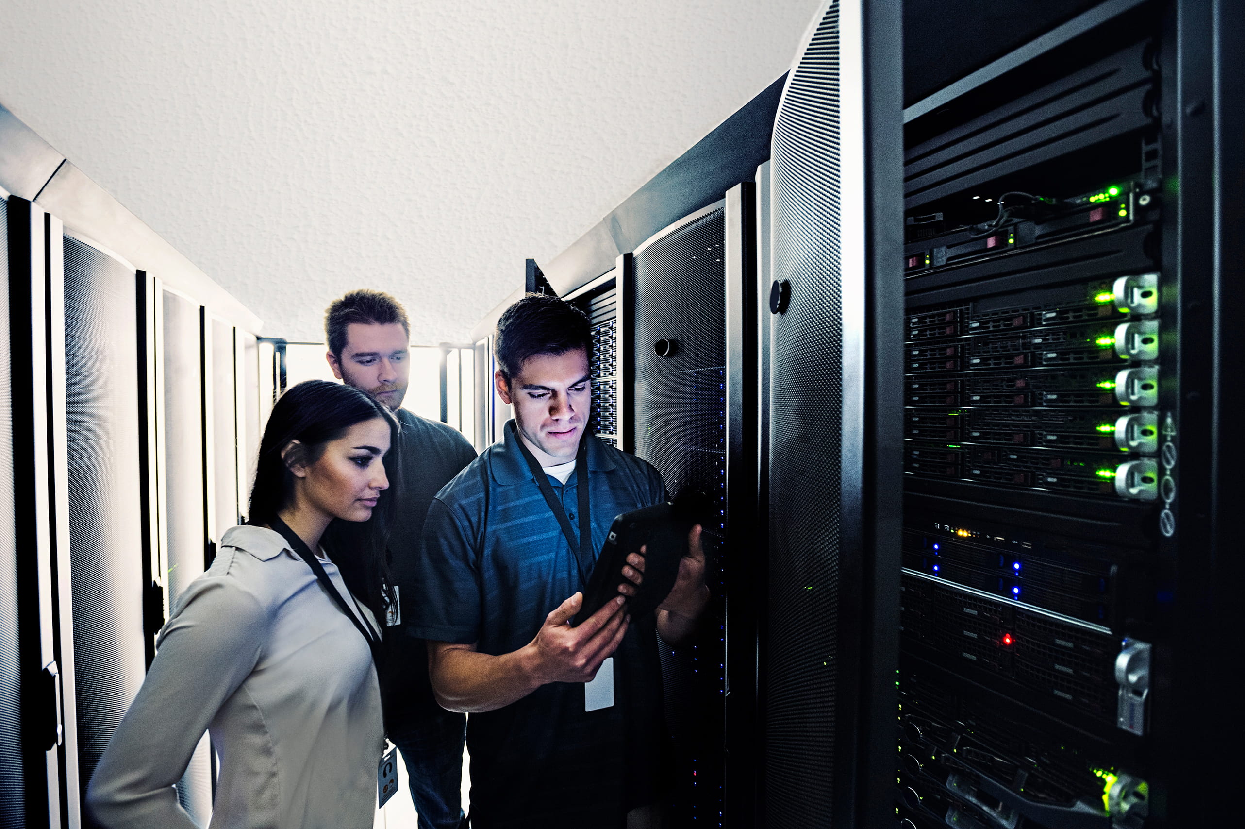 Technicians using digital tablet in server room