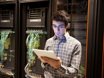 Male IT tech in front of servers