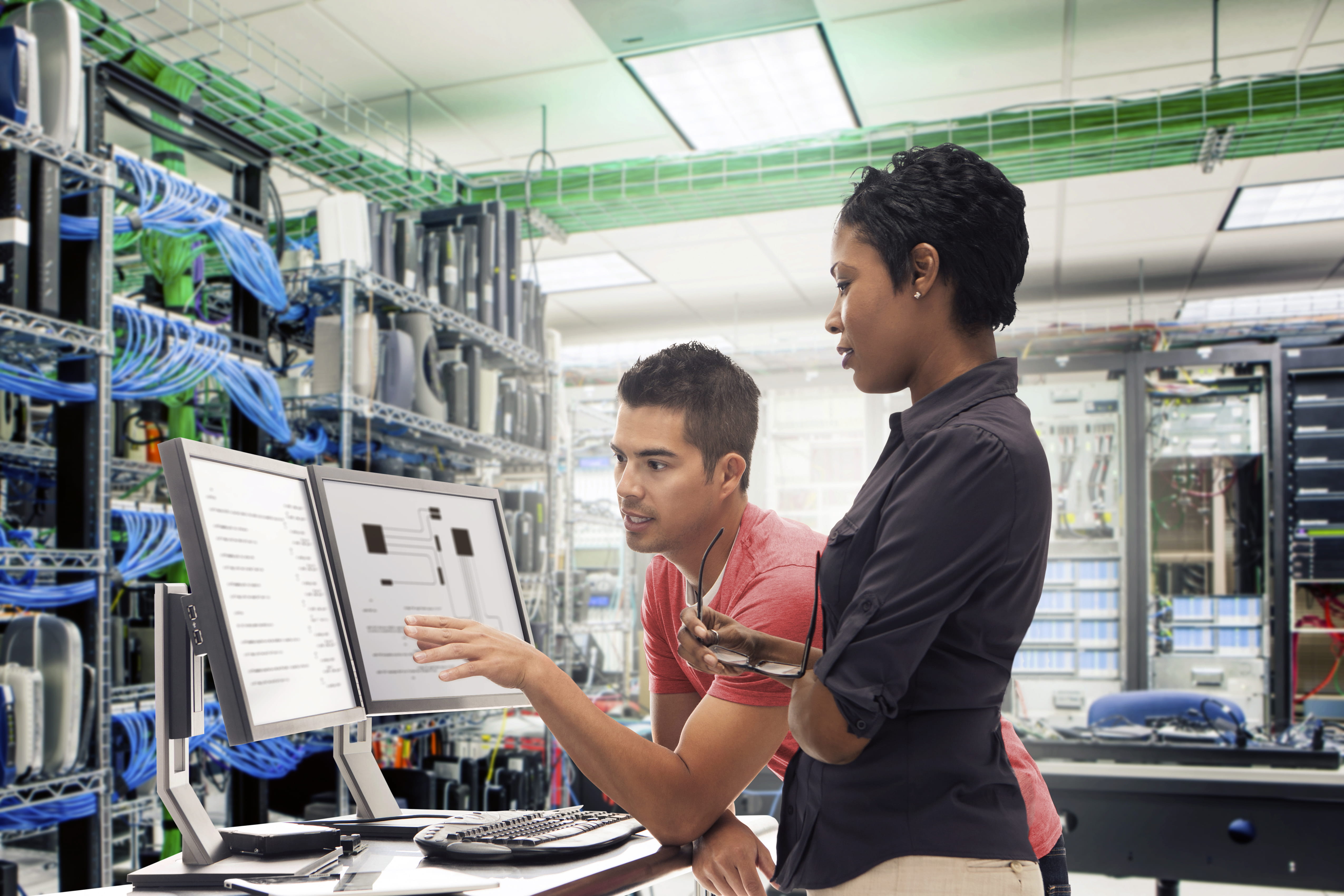 Business people working in server room