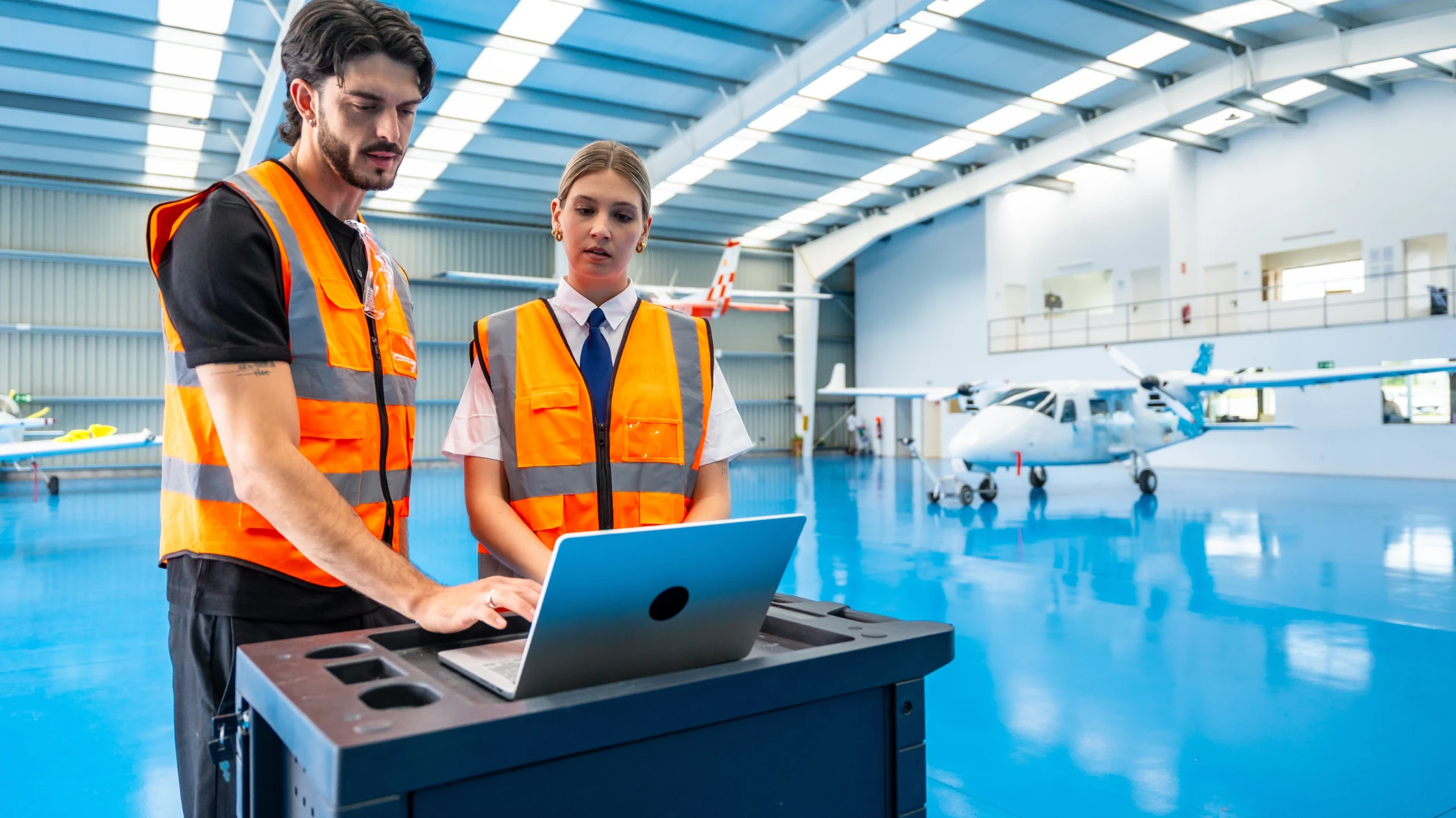 Deux professionnels de l’aéronautique avec un aéronef en arrière-plan, représentant une entreprise qui a surmonté la pénurie de main-d’œuvre.