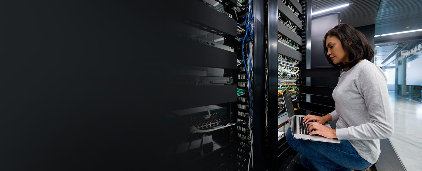 Female IT worker works on server