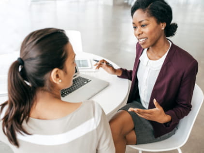 2 women meeting around computer