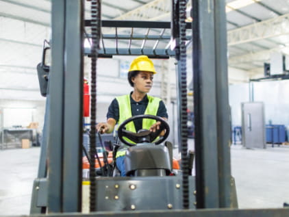 Female forklift operator inside plant