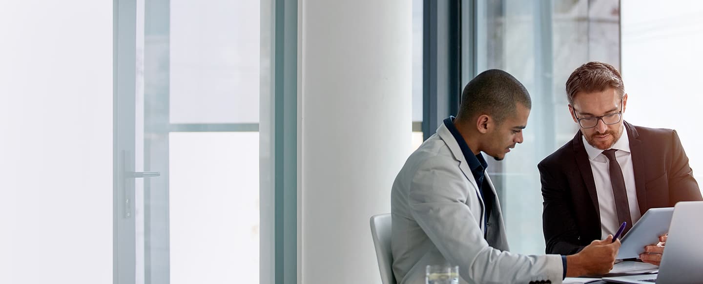 2 men conferring in modern office space